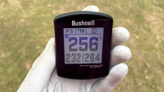 Bushnell Phantom 2 Slope GPS held aloft on the golf course