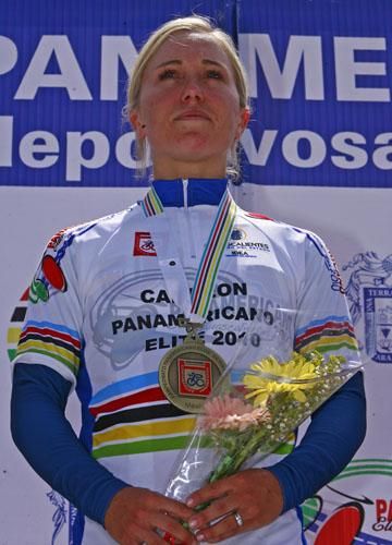 Shelley Evans stands proudly on the podium as the women's champion.
