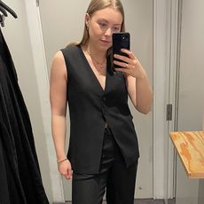 Woman in dressing room wearing linen waistcoat and linen trousers