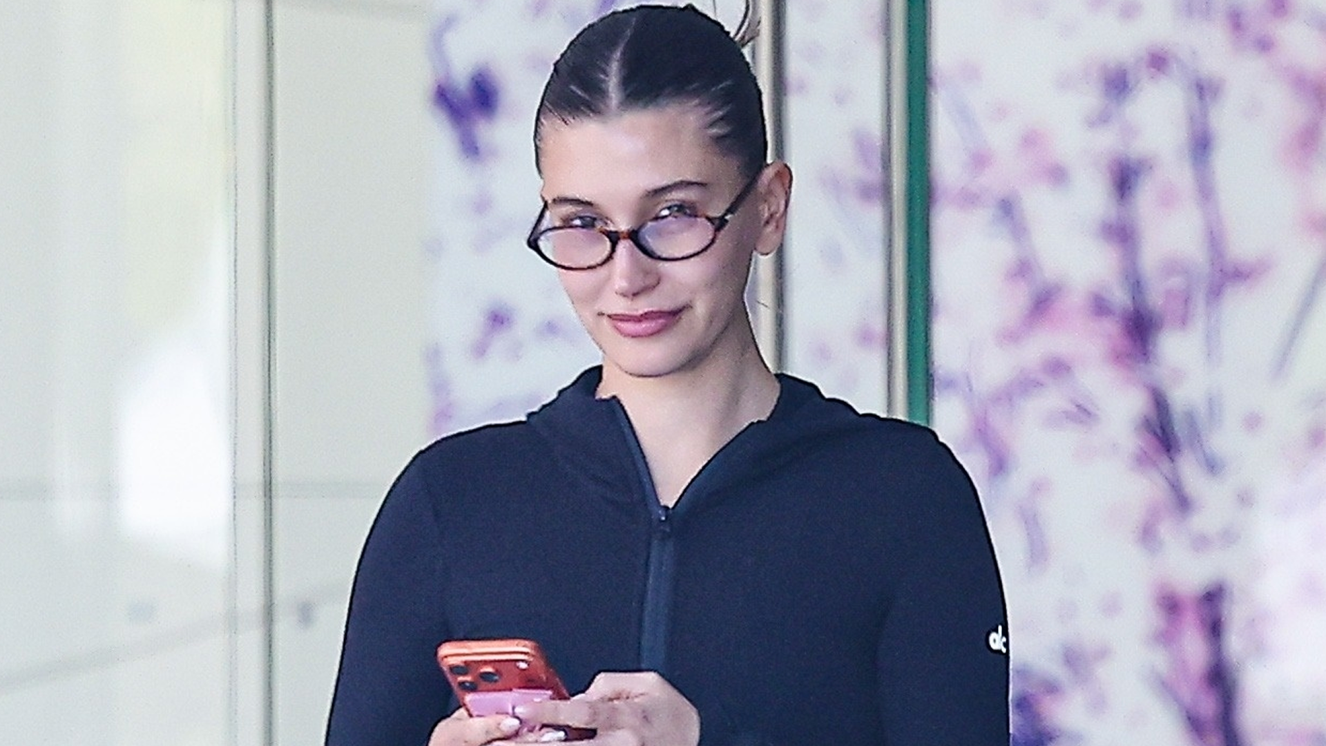 Hailey Bieber tapped into the sportif trend in track pants, a fitted jacket, and chunky black sneakers