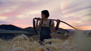 A shot from the upcoming Zack Snyder film Rebel Moon of Sofia Boutella standing in a field