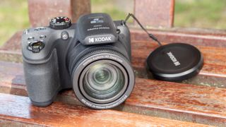 Kodak PixPro AZ405 digital camera in black on a wooden slatted table