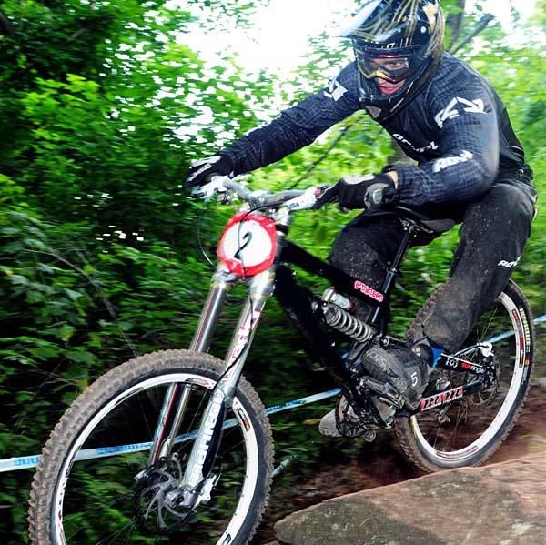 Chris Heath riding off a big drop