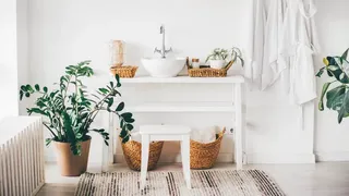 White bathroom with rattan baskets