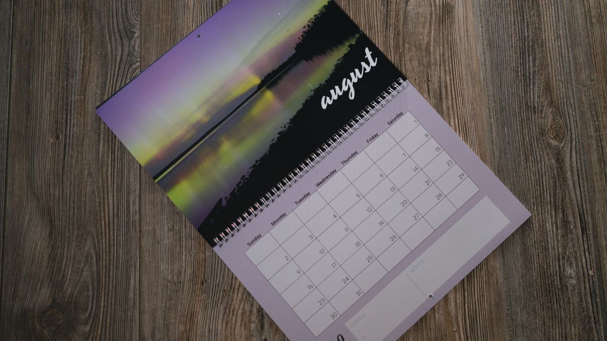 A photo calendar from Vistaprint on a wood background