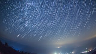 Perseid meteor shower over Okayama, Japan. Shooting star through the middle of the frame.