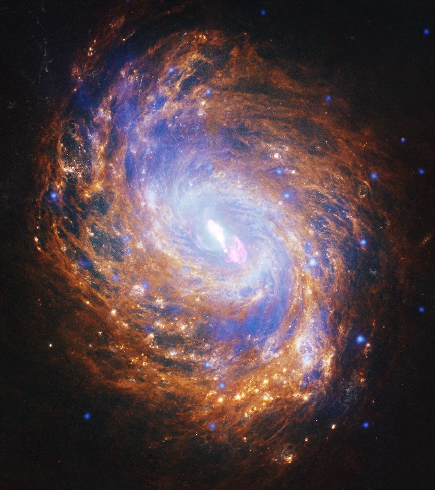 Combining X-ray, optical, infrared, and radio images creates a colorfully detailed photograph of the NGC 1068 galaxy