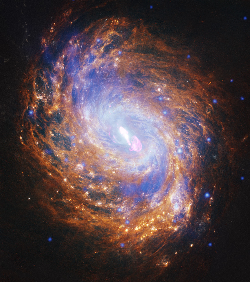 Combining X-ray, optical, infrared, and radio images creates a colorfully detailed photograph of the NGC 1068 galaxy