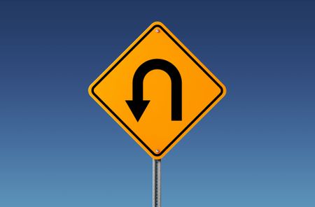 Yellow U Turn Sign Isolated On Blue Sky