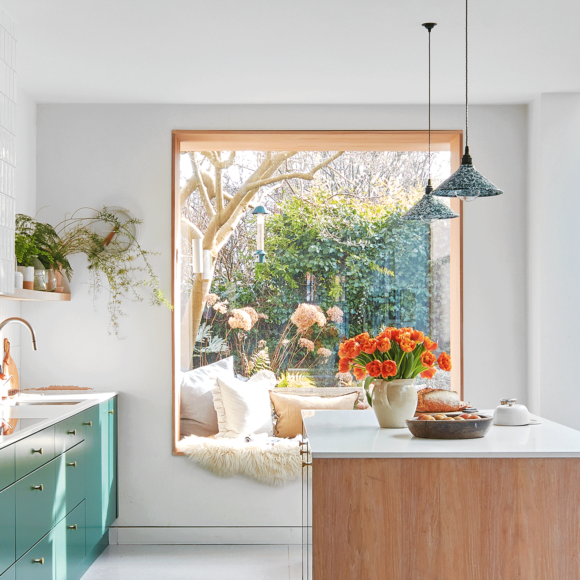 an oriel window with a built in seat in a large open plan kitchen