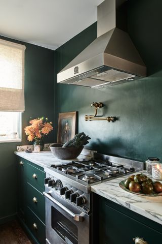 A small kitchen with a dark paint color