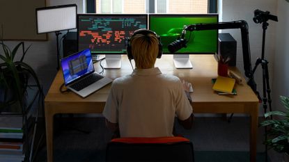 A person using a Mac with Final Cut Pro.