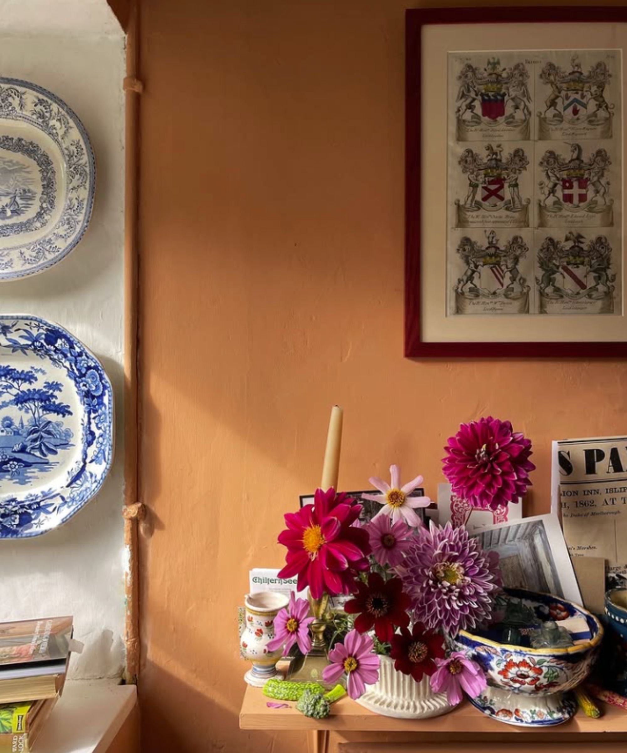 A side table in a kitchen with orange paint on the walls