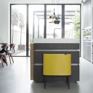 dining room with yellow touch bin and white flooring