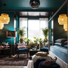 living room dark colour wall chairs window and plant
