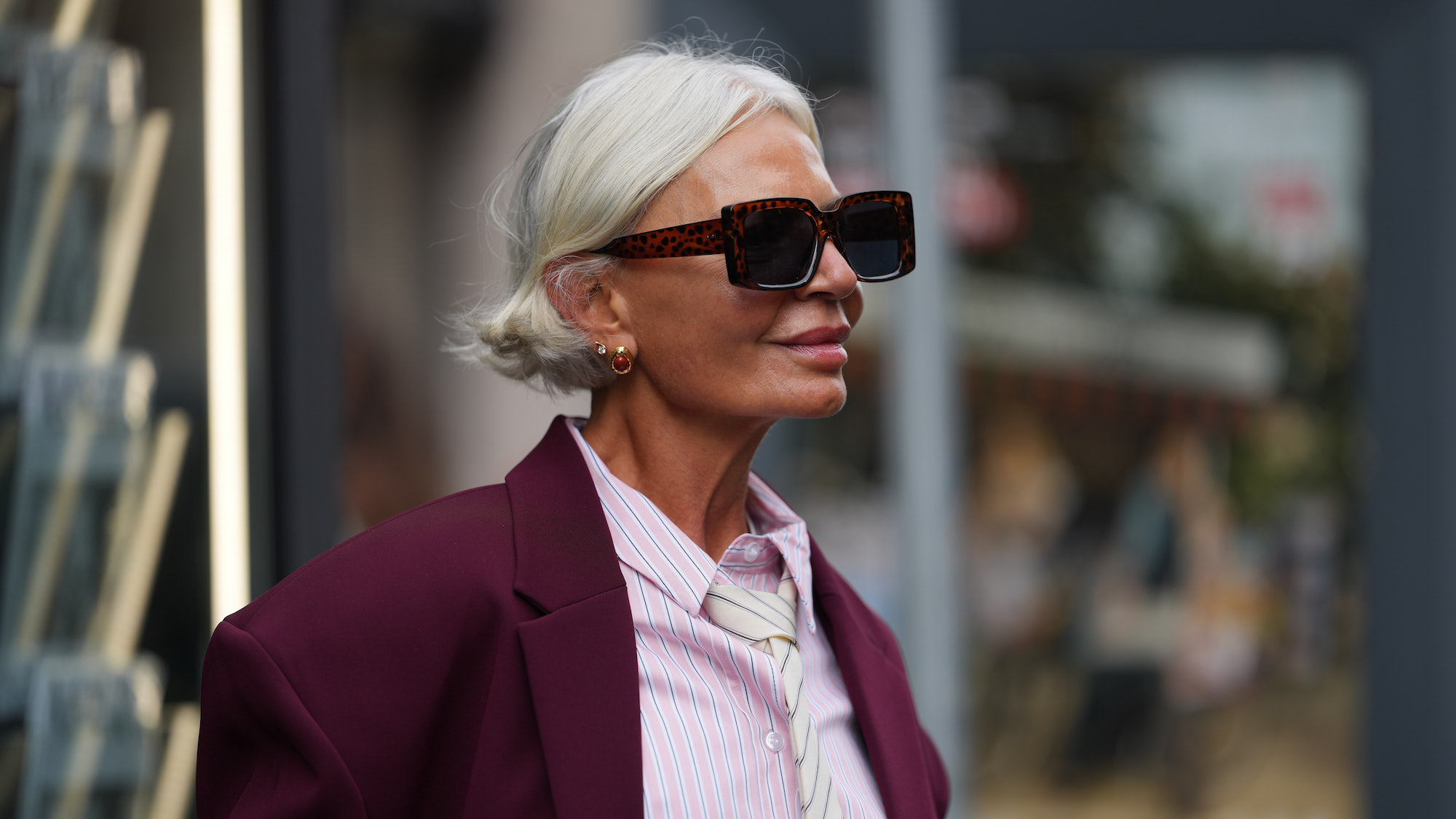 Grece Ghanem wears short platinum blonde bob with burgundy blazer