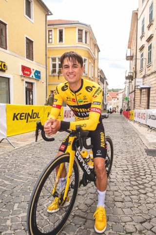 Milan Vader astride his bike, smiling to camera, in Croatia