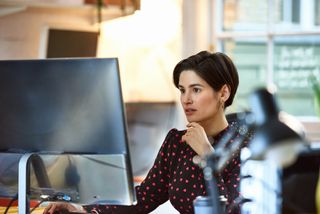 Female tech worker working at computer station