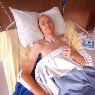 Chris Froome gives the thumbs up from his hospital bed in St Etienne
