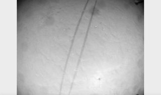 Tracks of NASA's Perseverance Mars rover, as spotted from above by the Ingenuity helicopter during its 28th flight on April 29, 2022.