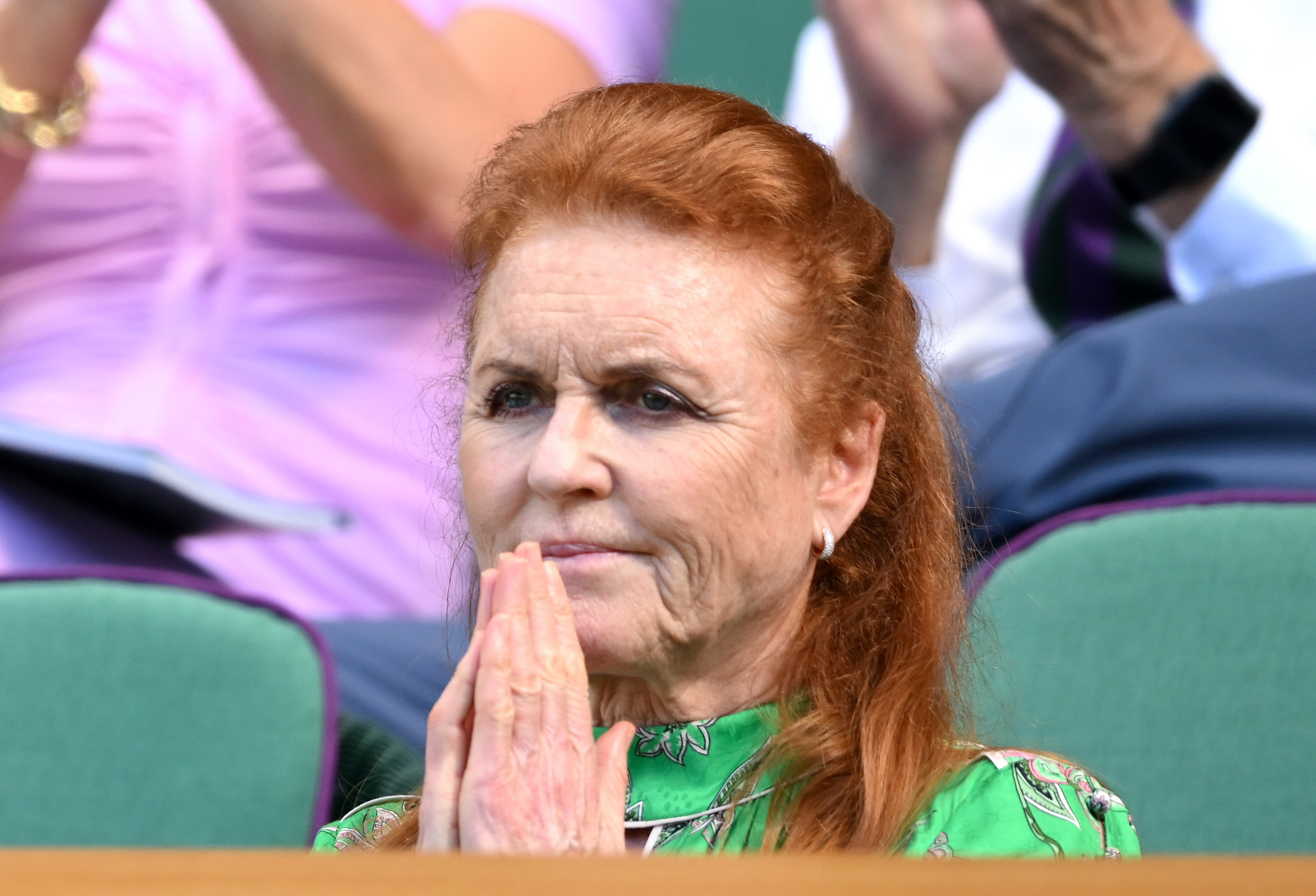 Sarah Ferguson sitting at Wimbledon with her palms pressed together