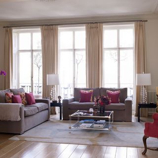 living area with wooden flooring and sofa set with cushions