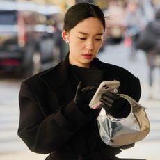 a woman wears a black coat