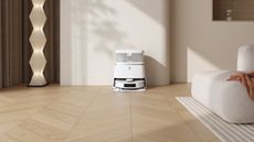 Ecovacs Deebot T30 Pro Omni in its self-cleaning dock by a wall