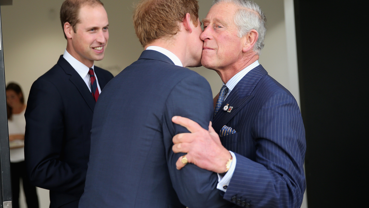 Prince Charles, Prince of Wales kisses his son Prince Harry as Prince William, Duke of Cambridge looks on ahead of the Invictus Games Opening Ceremony at Queen Elizabeth II Park on September 10, 2014 in London, England.