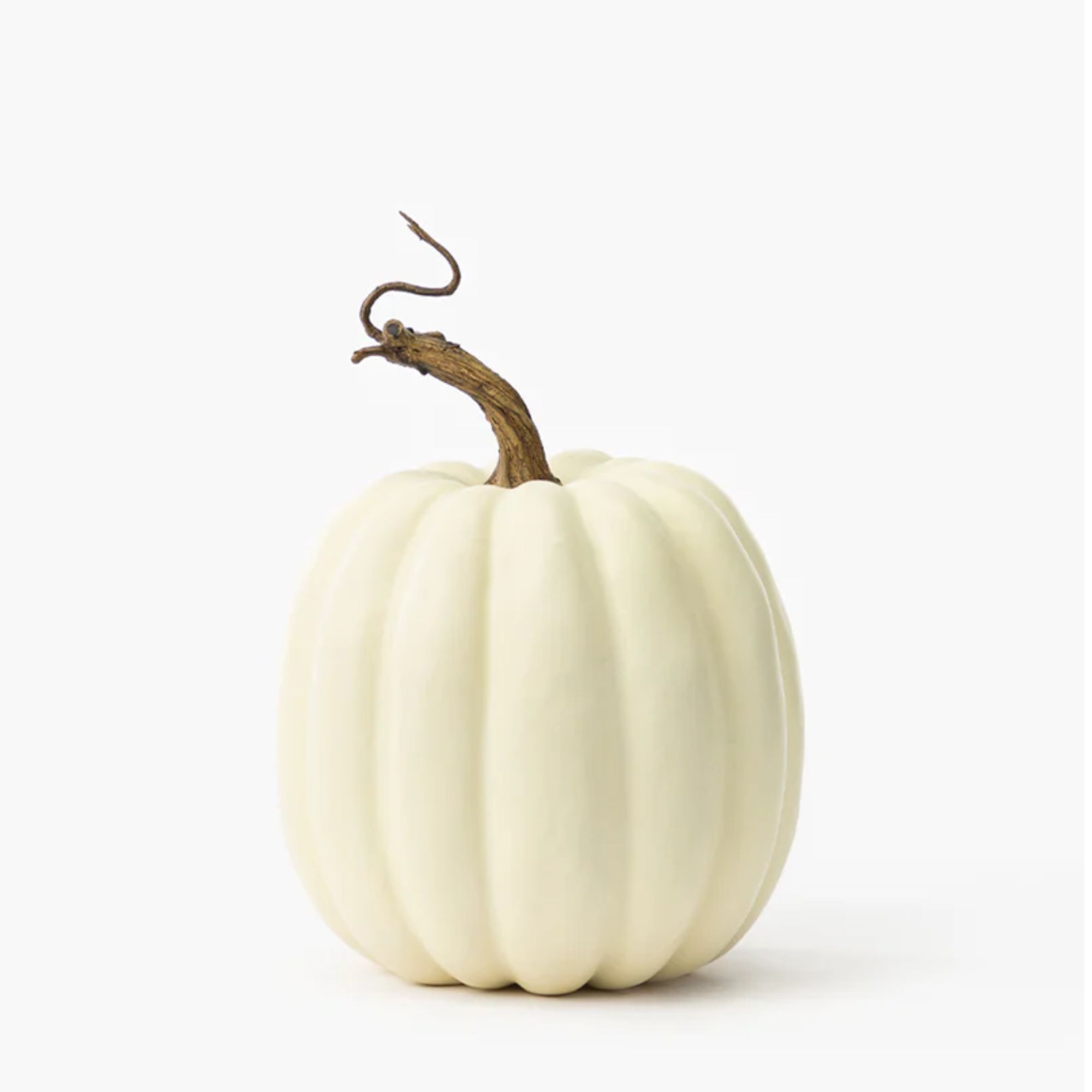 White faux pumpkin with brown stem