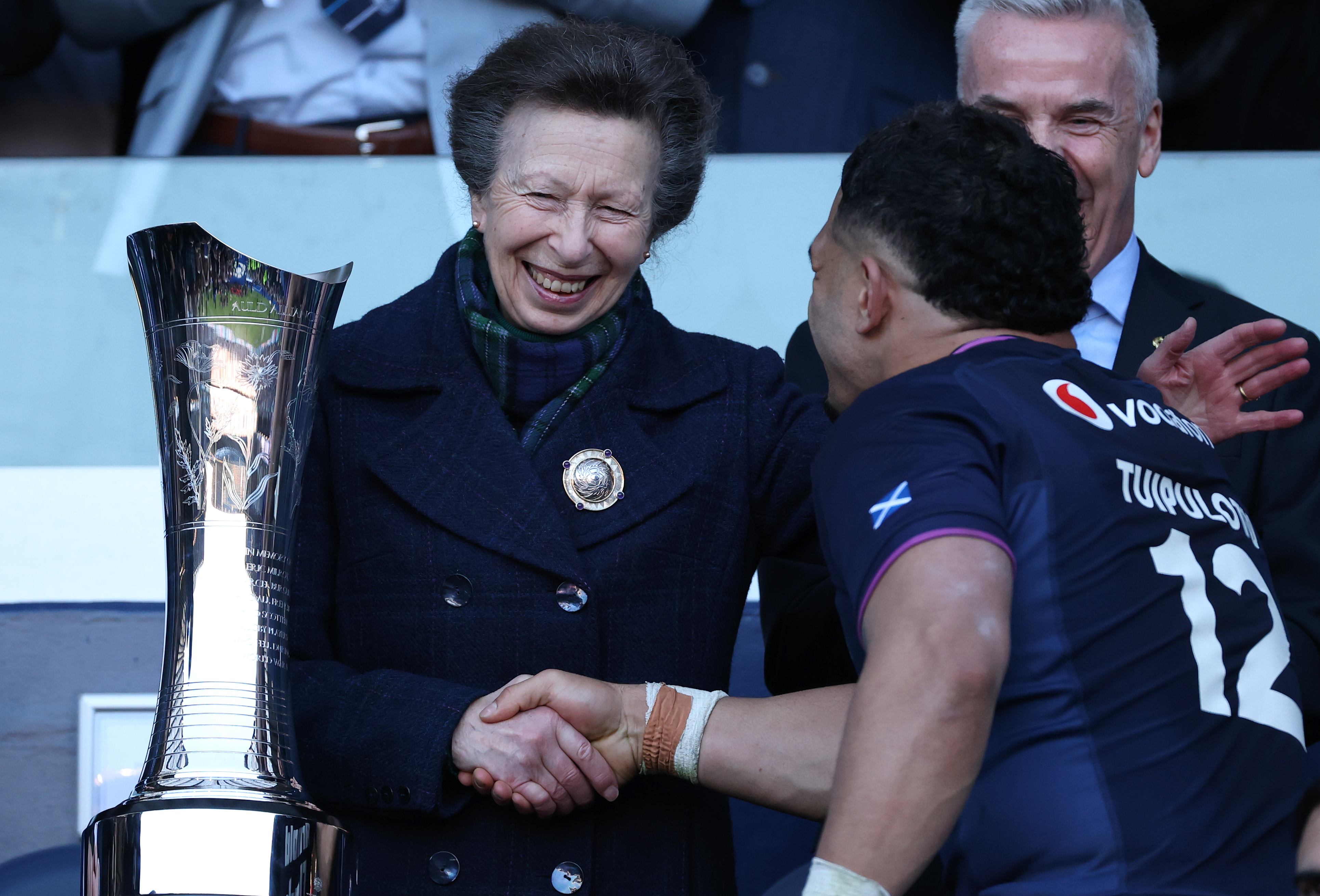 Princess Anne shaking hands with Scotland rugby captain Sione Tuipulotu