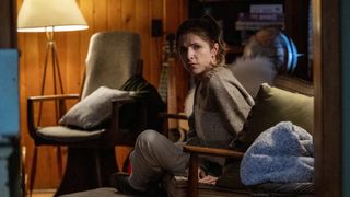 A still from the movie Alice Darling of Anna Kendrick as Alice, sat on a chair looking pensively at the camera