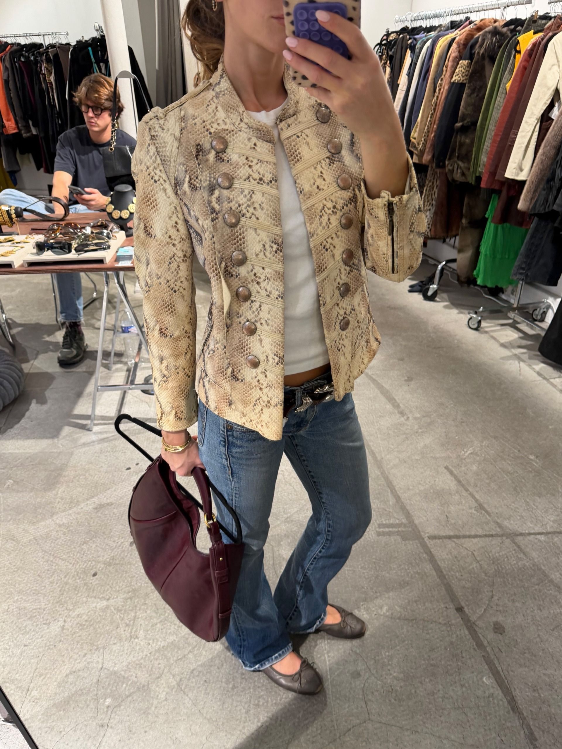 Woman wearing a snakeskin jacket.