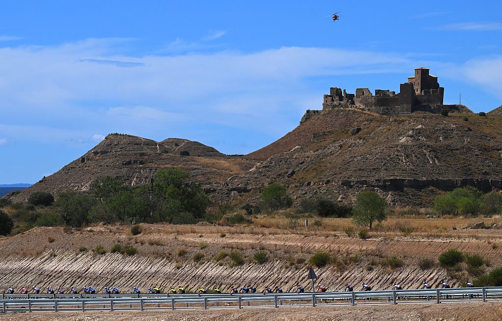 ZARAGOZA, SPAIN - AUGUST 30: A general view of the peloton competing close to the Montearagon Castle during the La Vuelta - 80th Tour of Spain 2025, Stage 8 a 163.5km stage from Monzon Templario to Zaragoza / #UCIWT / on August 30, 2025 in Zaragoza, Spain. (Photo by Tim de Waele/Getty Images)