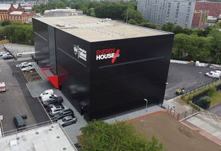 An exterior shot of the Bellway homes experimental house, which resembles a large black box
