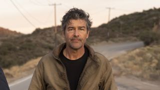 Kyle Chandler walking down a street in HBO's Lanterns