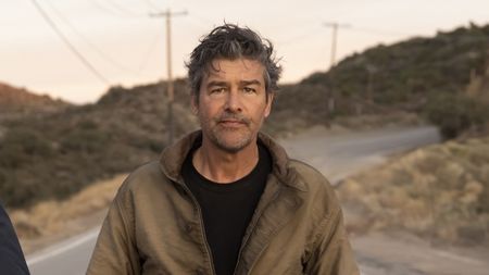 Kyle Chandler walking down a street in HBO's Lanterns