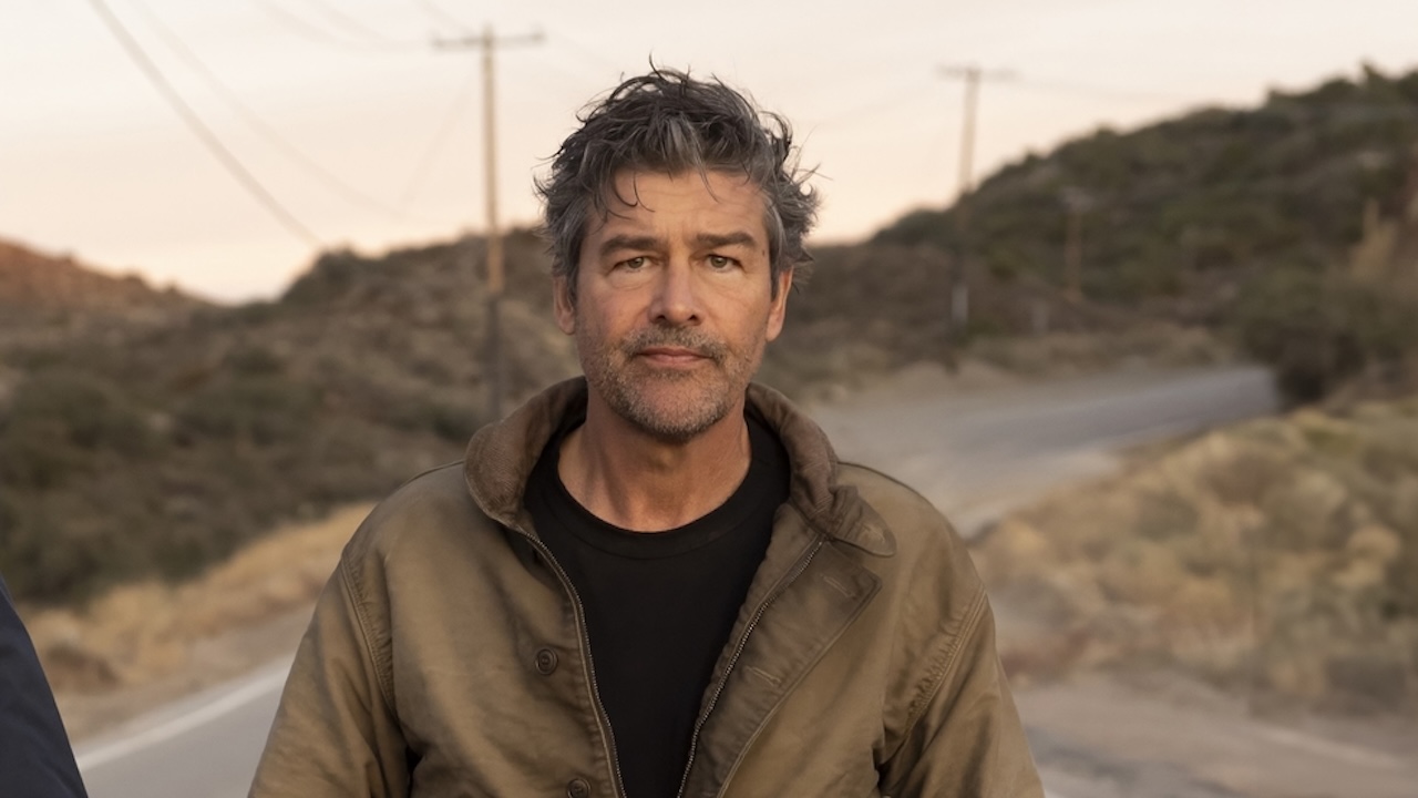 Kyle Chandler walking down a street in HBO's Lanterns