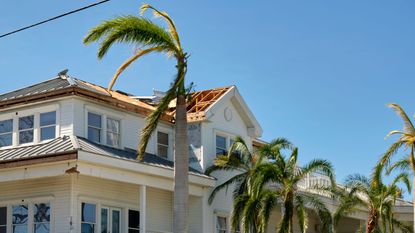 house with damaged roof from hurricane