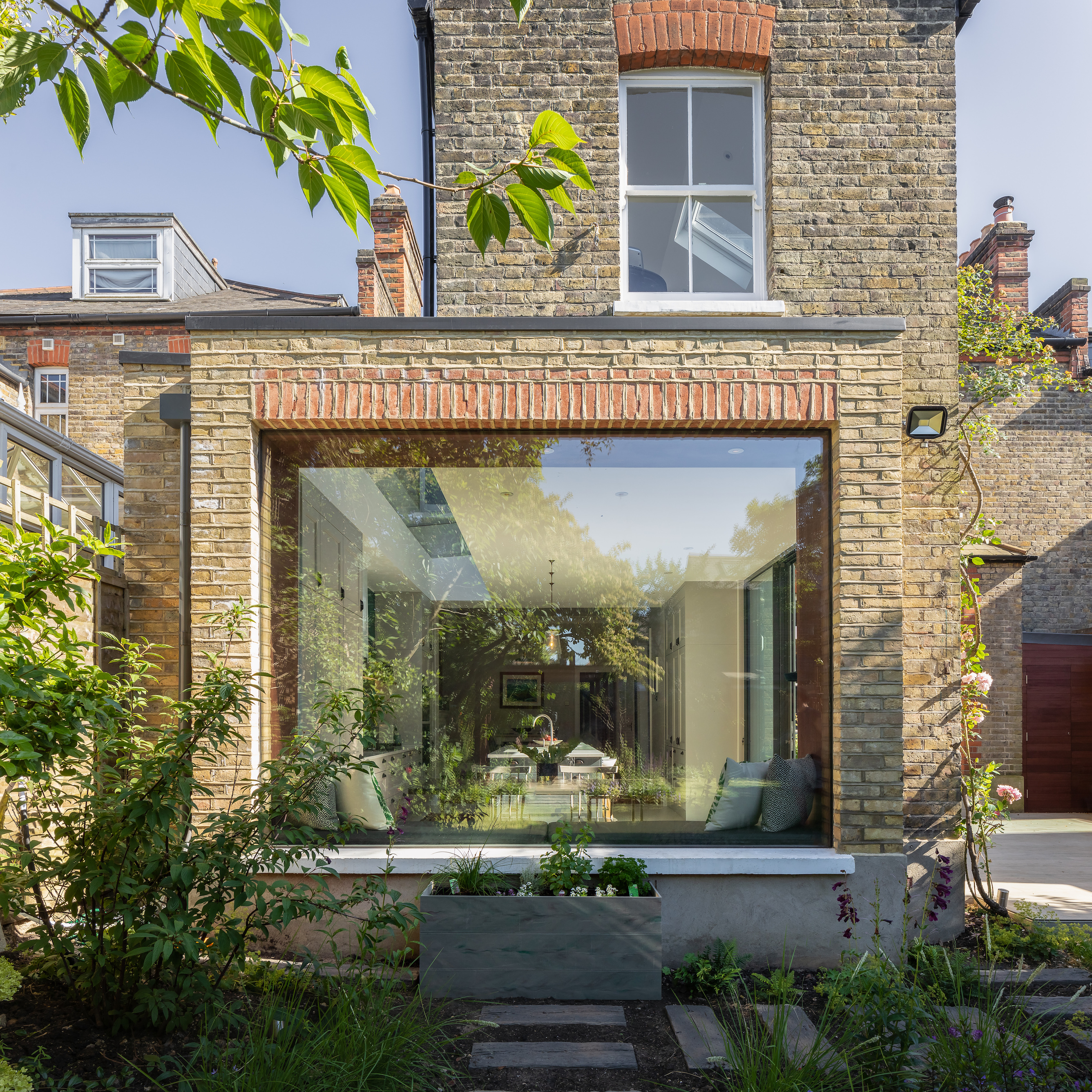 small wrap around extension in brick to a terrace house