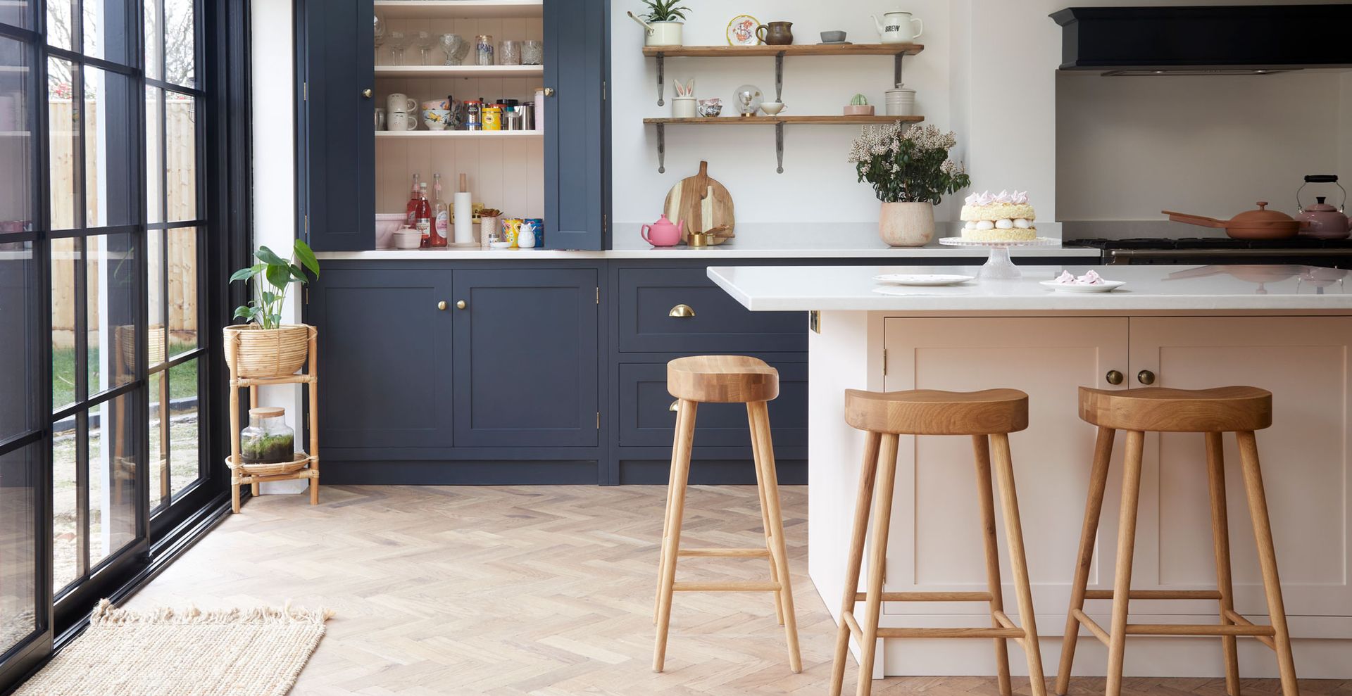Kitchen painted in Farrow and Ball's Railing with the kitchen island painted in Pink Ground to contrast to show how to make a kitchen look expensive on a budget