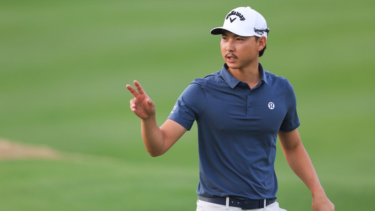 Min Woo Lee salutes the crowd after holing a putt