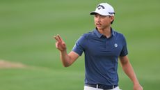 Min Woo Lee salutes the crowd after holing a putt