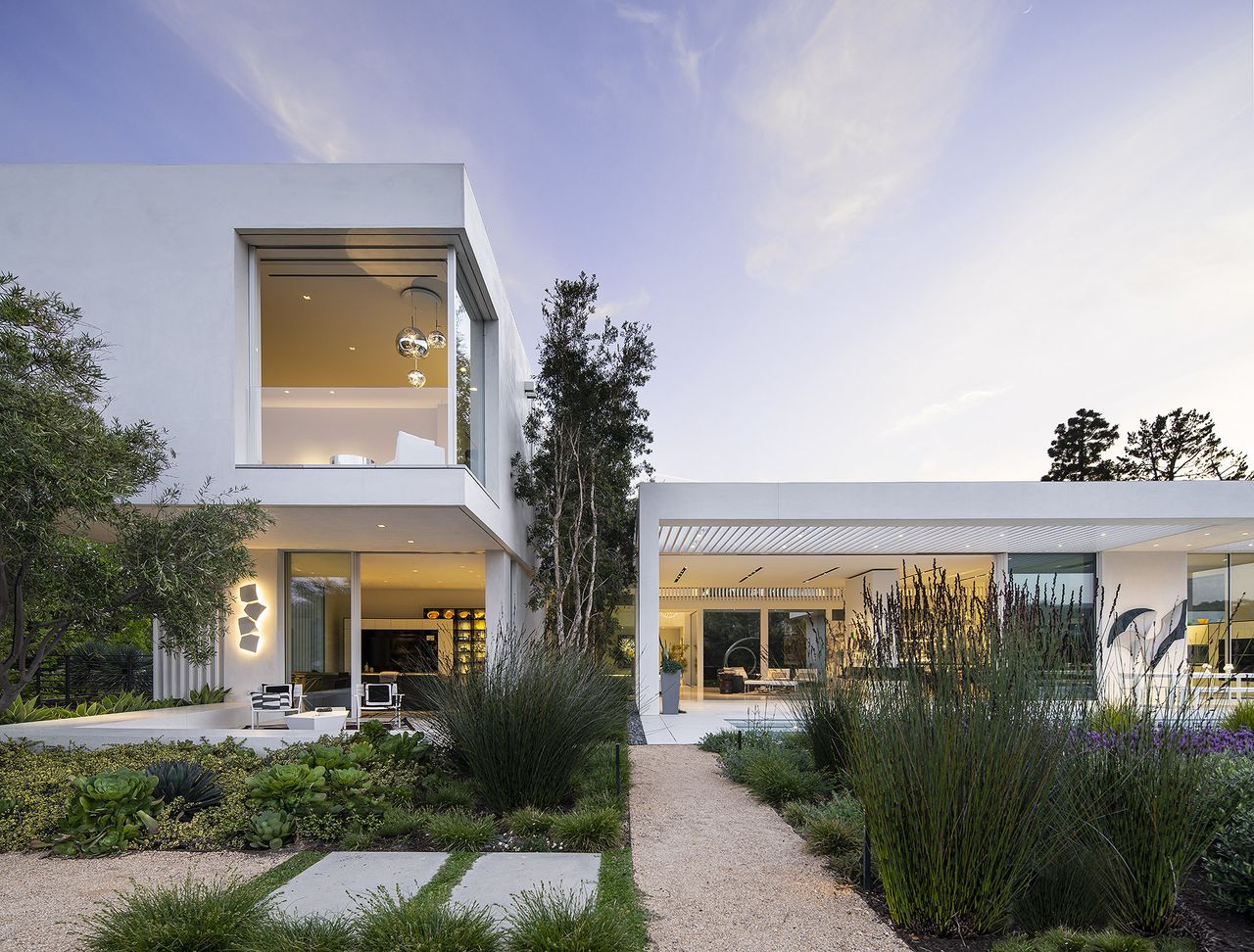 Exterior in dusk with stone pathway and garden of the Castlegate Residence