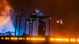 Barry Can't Swim behind a pair of decks on stage