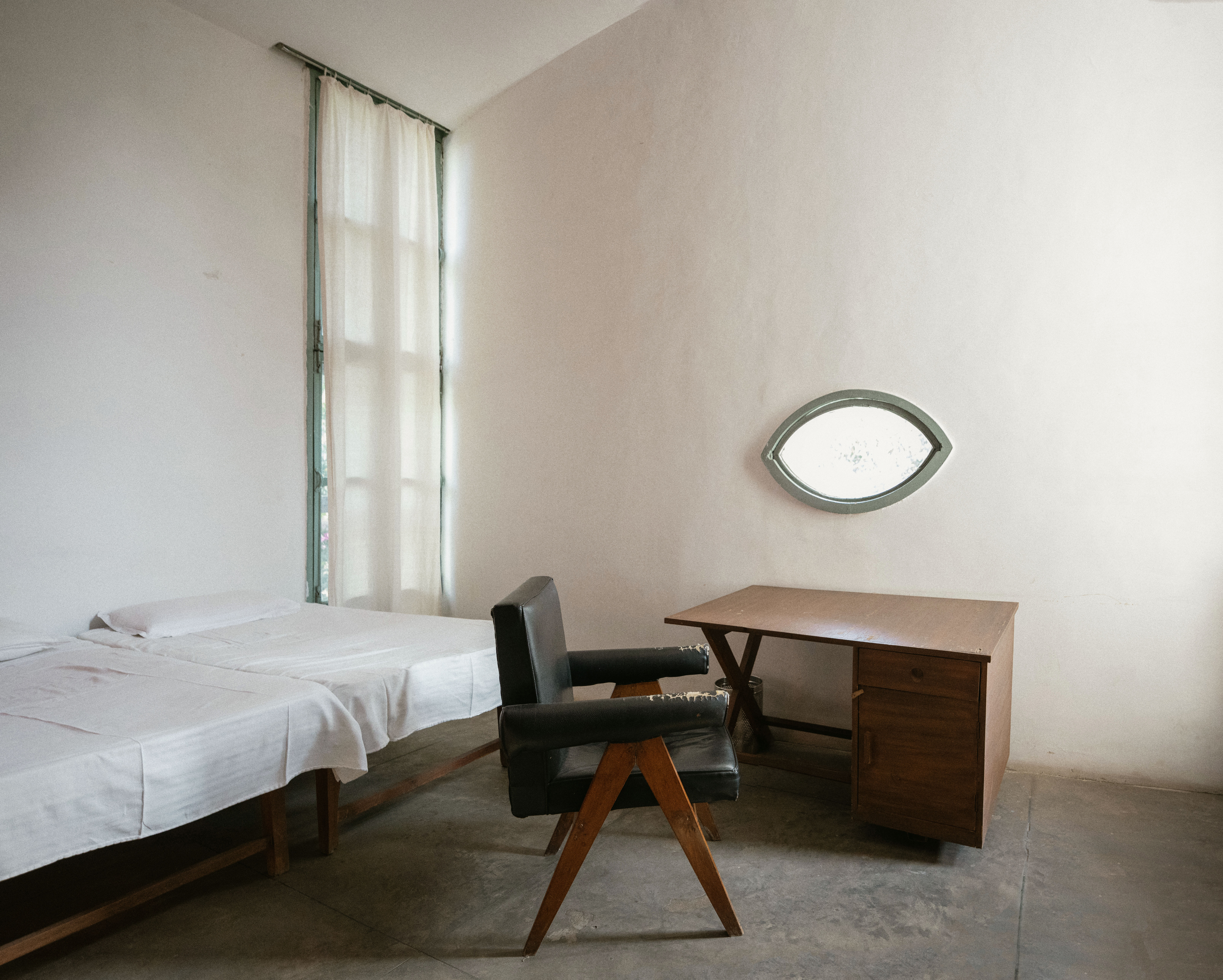 Pierre Jeanneret house bedroom, a stark space with an eye shaped window