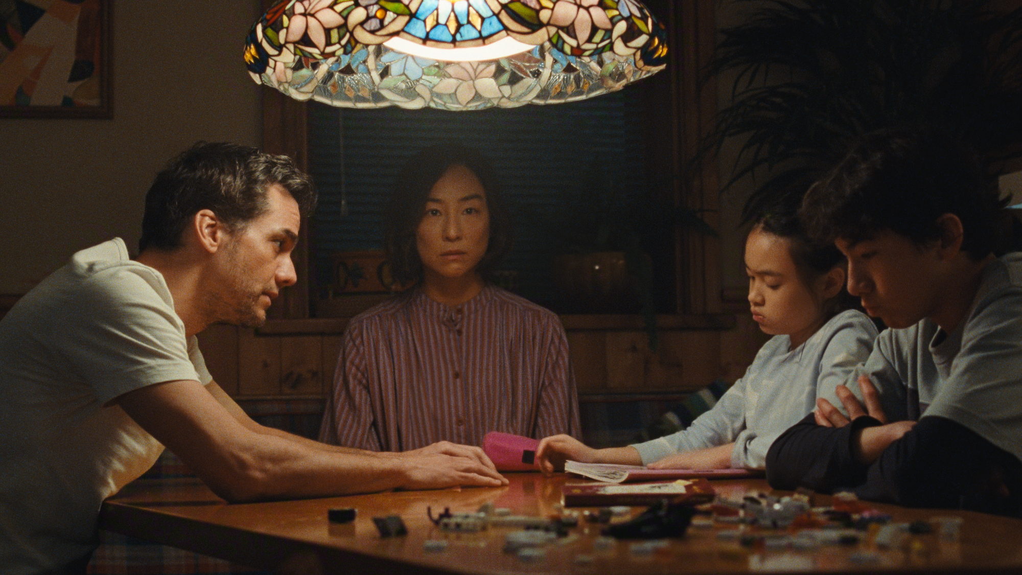 The Delgados at the table in The Last House.