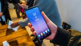 Samsung Galaxy S8 in hand with screen on