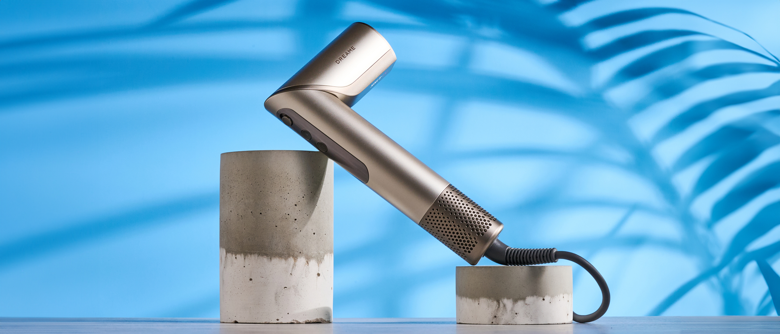 Dreame Dazzle air styler photographed in front of a blue background