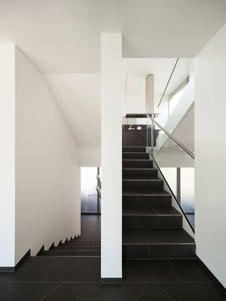 Black staircase with white walls